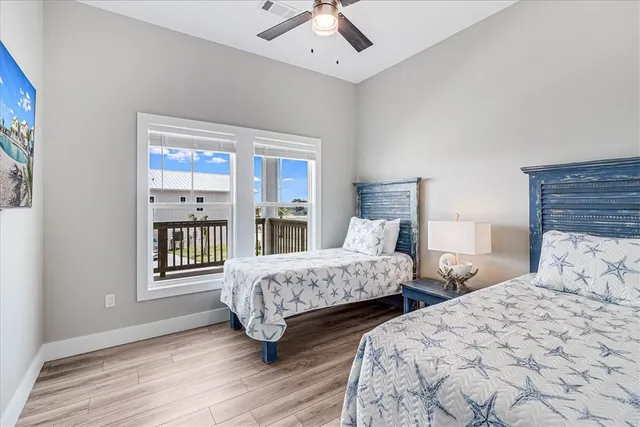 a bedroom with two beds and a window