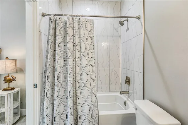 a bathroom with a bathtub and shower