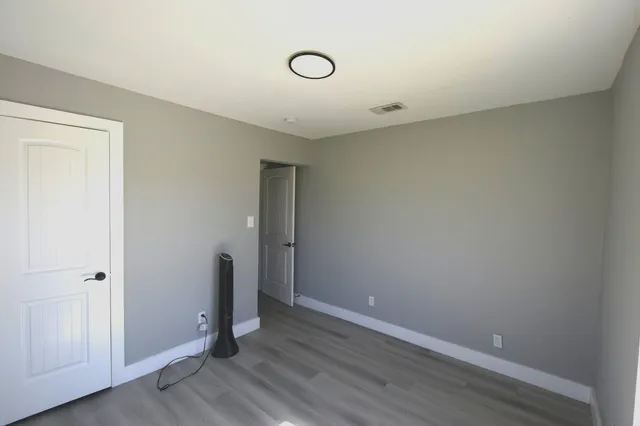 a view of room with wooden floor
