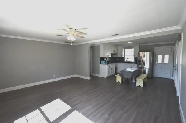 a view of a living room and wooden floor