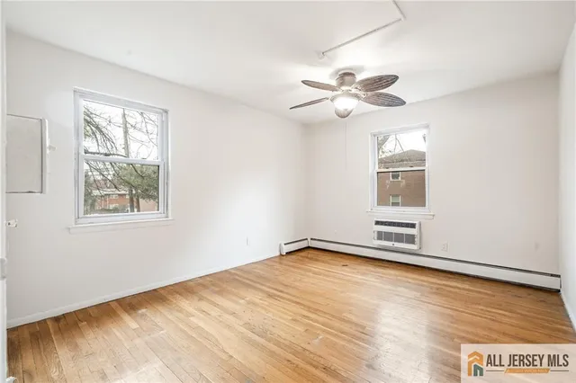 a view of a room with a window and wooden floor
