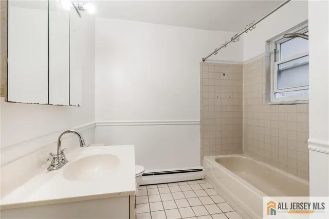 a bathroom with a tub a sink and a shower