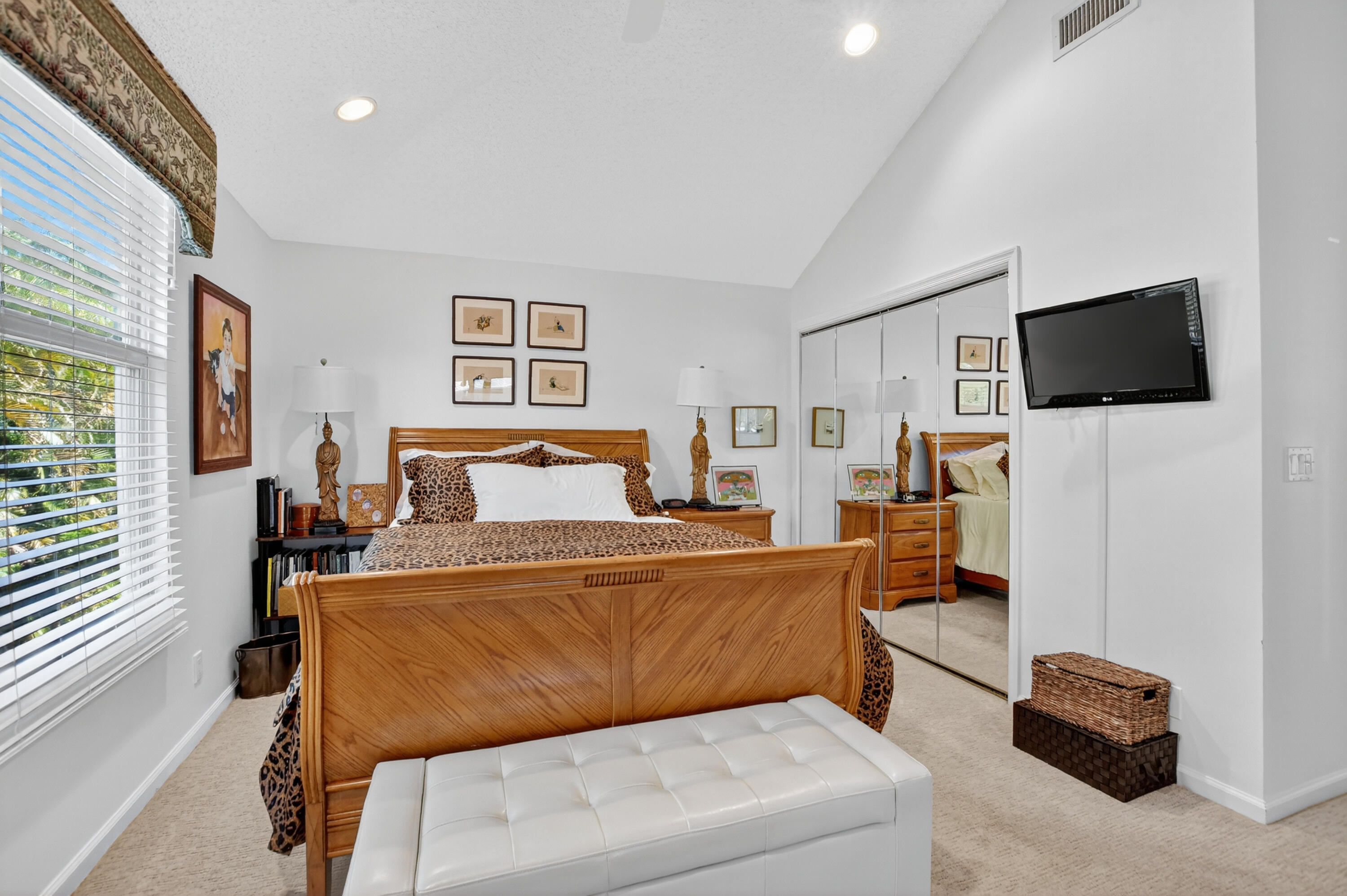 20220 Boca W Drive, Unit 202 Boca Raton, FL 33434 - Photo 21 of 129 a bedroom with a bed and a flat screen tv