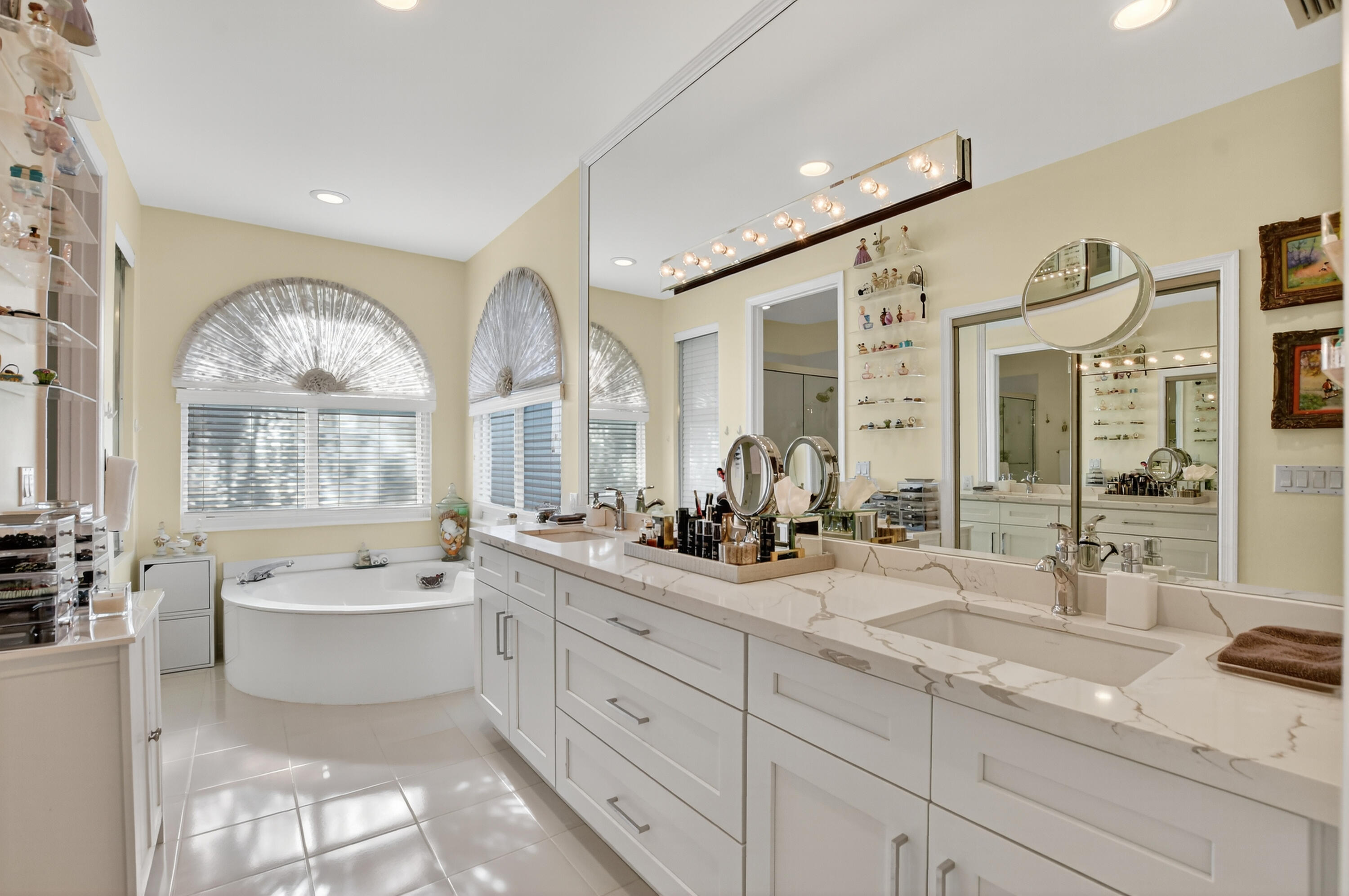 20220 Boca W Drive, Unit 202 Boca Raton, FL 33434 - Photo 30 of 129 a spacious bathroom with a double vanity sink a mirror a bathtub and next to a window