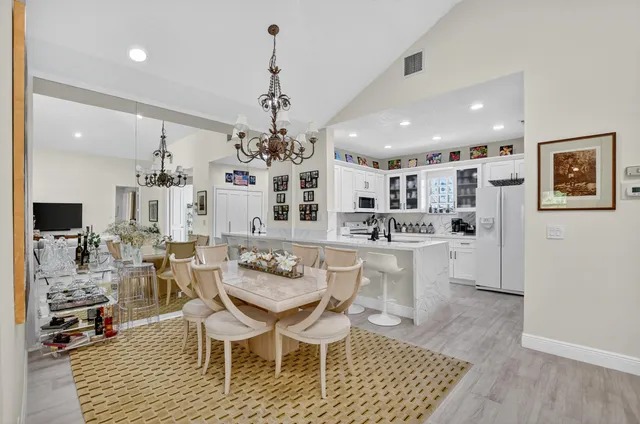 a kitchen with stainless steel appliances granite countertop white cabinets a sink and dishwasher