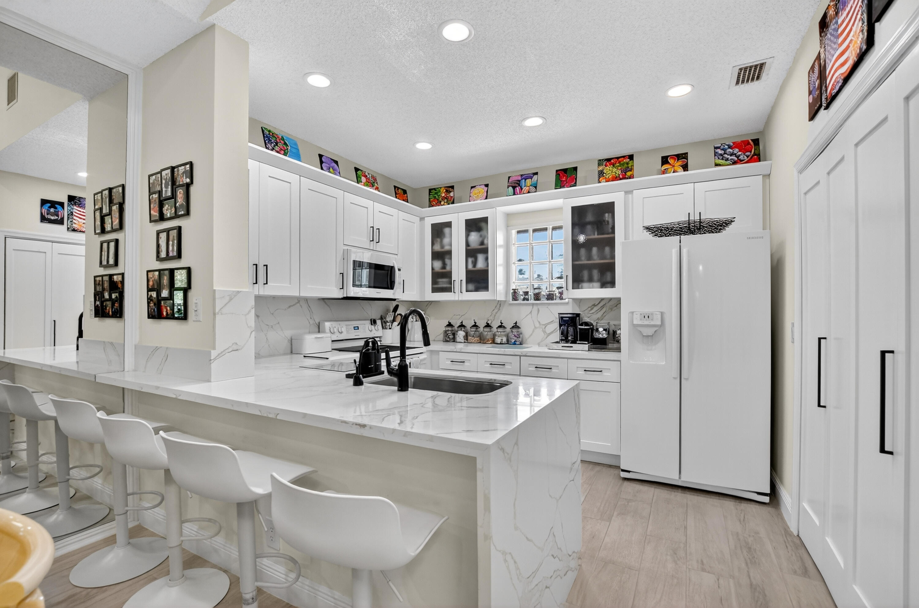 20220 Boca W Drive, Unit 202 Boca Raton, FL 33434 - Photo 10 of 129 a kitchen with stainless steel appliances granite countertop a sink and a refrigerator