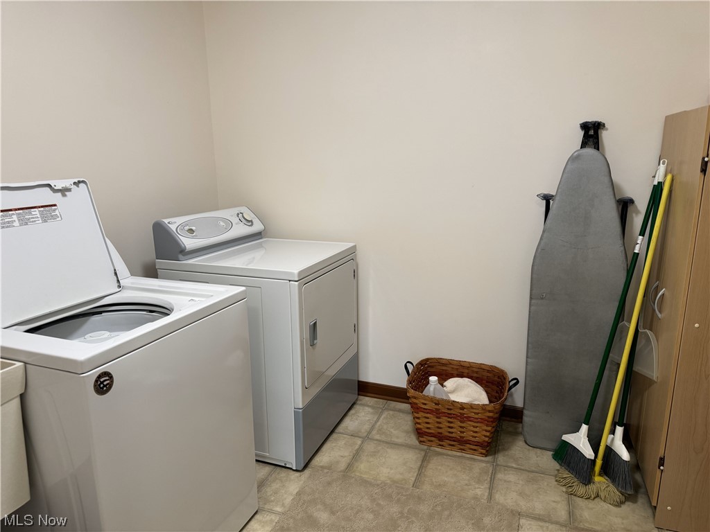 3215 Grill Road Clinton, OH 44216 - Photo 35 of 36 Laundry room featuring light tile flooring and washing machine and dryer