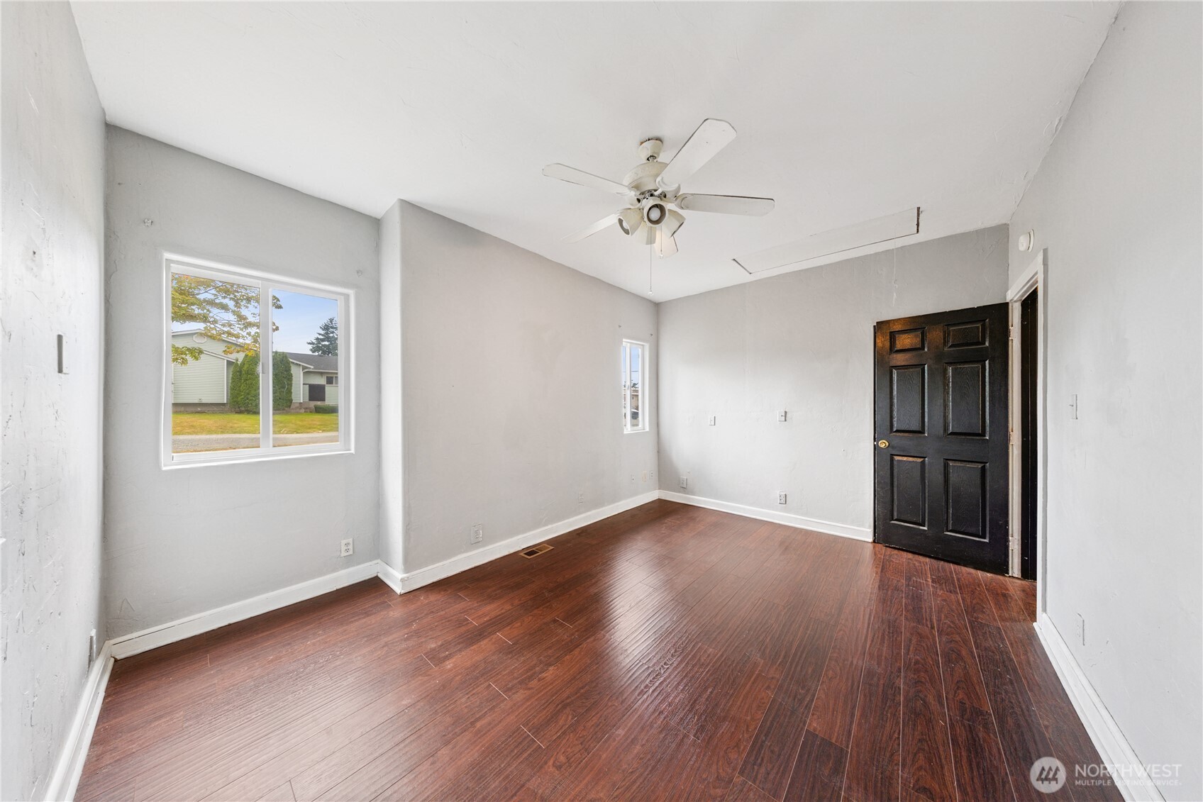 619 35th Street Anacortes, WA 98221 - Photo 9 of 40 a view of an empty room with a window and wooden floor