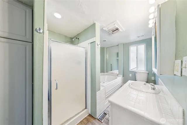a spacious bathroom with a double vanity sink mirror and shower