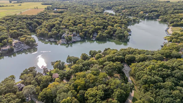 an aerial view of a houses with outdoor space and lake view