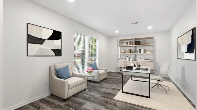 a living room with furniture and a painting on the wall