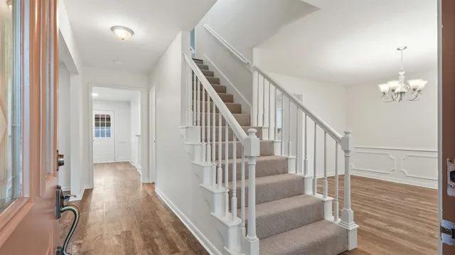 a view of entryway and hall with wooden floor