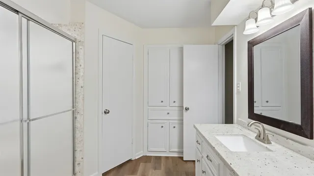 a bathroom with a granite countertop sink and a mirror