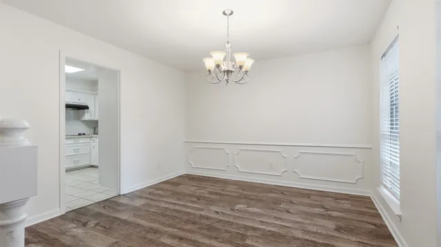 a view of a room with wooden floor