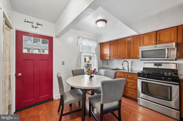 a kitchen with a dining table and chairs