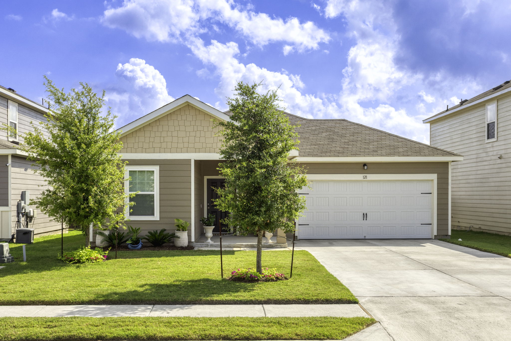 a house view with swimming pool and garden space