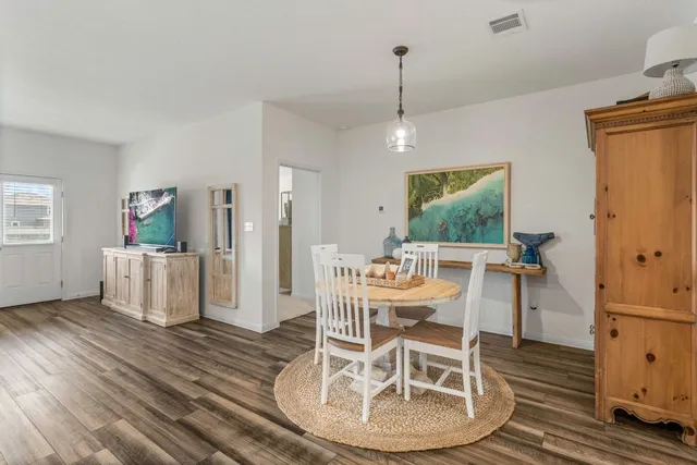 a living room with furniture kitchen view and a window
