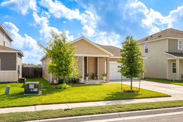 a front view of a house with garden