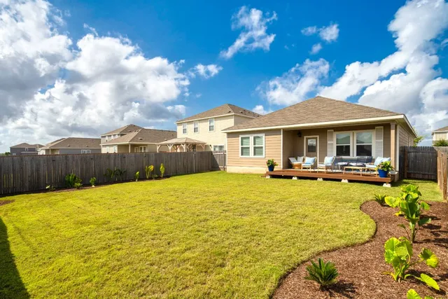 a view of a house with swimming pool and sitting area