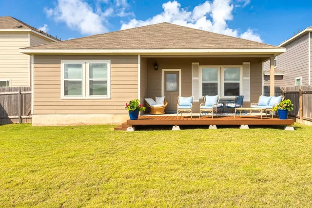 a swimming pool view with a seating space