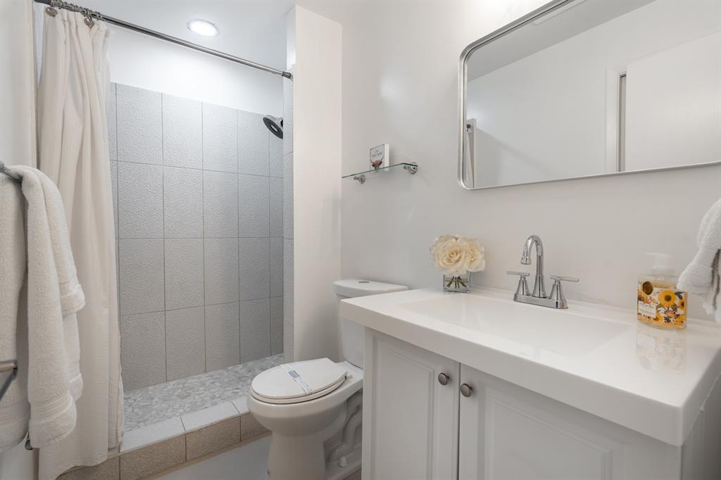 927 Northeast 199th Street, Unit 202 Miami, FL 33179 - Photo 11 of 39 a bathroom with a sink a toilet and shower