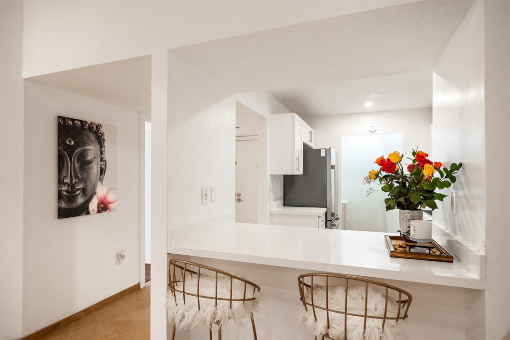 927 Northeast 199th Street, Unit 202 Miami, FL 33179 - Photo 14 of 39 a view of living room with furniture and flowers