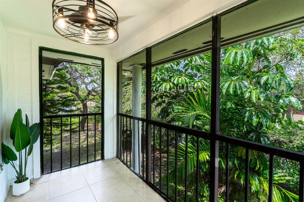 927 Northeast 199th Street, Unit 202 Miami, FL 33179 - Photo 15 of 39 a view of a porch with a yard