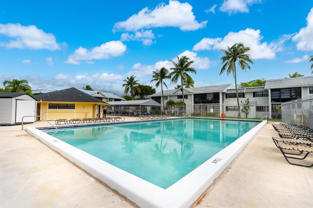 927 Northeast 199th Street, Unit 202 Miami, FL 33179 - Photo 16 of 39 a view of a swimming pool with a patio