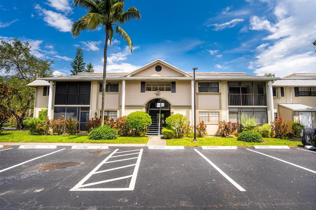927 Northeast 199th Street, Unit 202 Miami, FL 33179 - Photo 20 of 39 a front view of a house with a yard