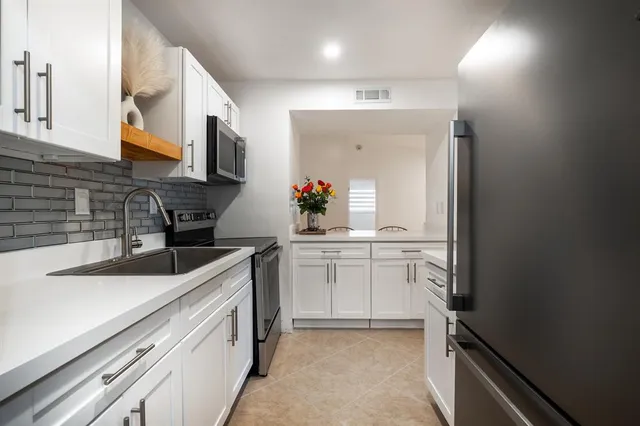 a kitchen with a sink and refrigerator