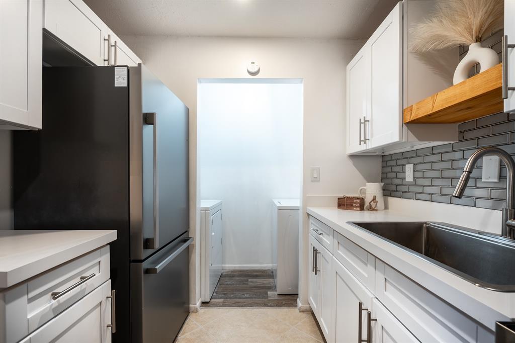 927 Northeast 199th Street, Unit 202 Miami, FL 33179 - Photo 25 of 39 a kitchen with a sink and refrigerator