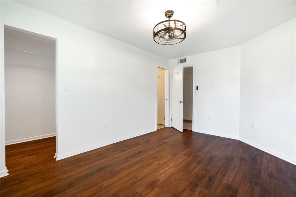 927 Northeast 199th Street, Unit 202 Miami, FL 33179 - Photo 36 of 39 a view of a hallway with wooden floor