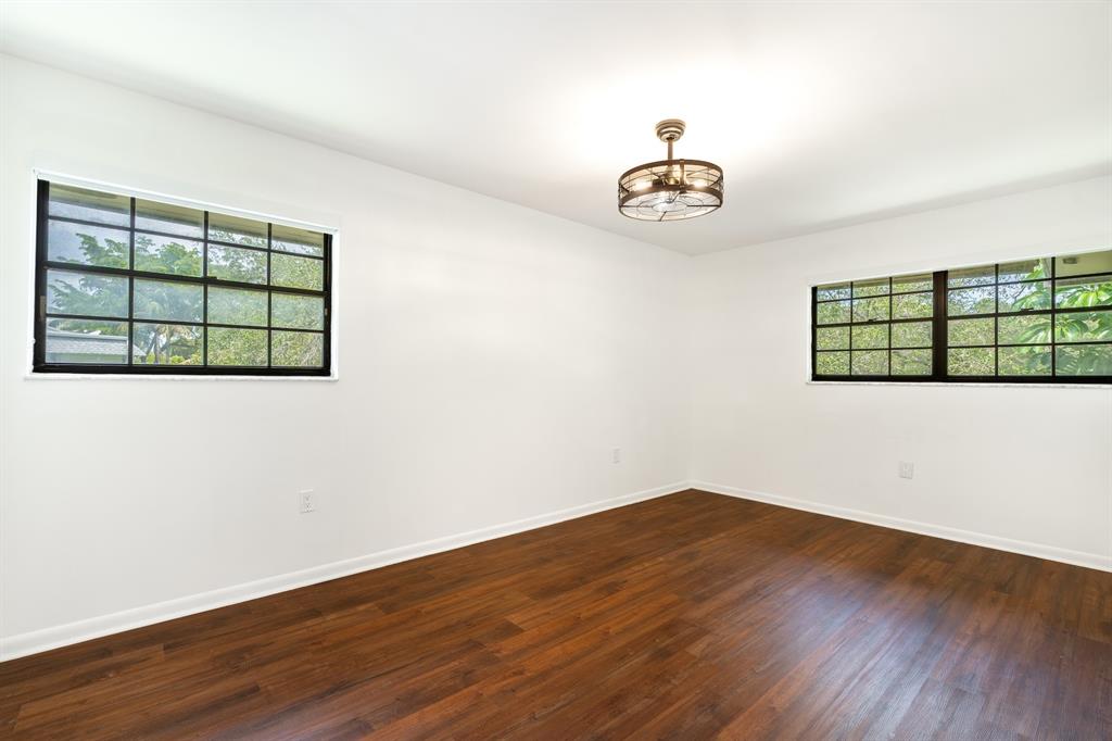 927 Northeast 199th Street, Unit 202 Miami, FL 33179 - Photo 5 of 39 an empty room with a window