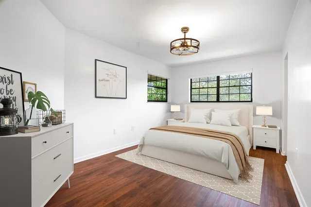 a bedroom with a bed and a chandelier