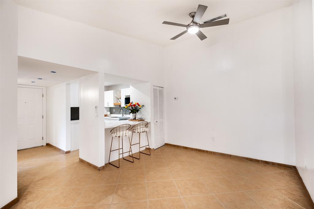 927 Northeast 199th Street, Unit 202 Miami, FL 33179 - Photo 10 of 39 a view of a kitchen with white cabinets and white appliances
