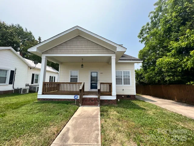 a view of a house with a yard patio and a small yard