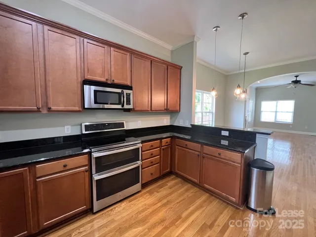 a kitchen with granite countertop wooden cabinets and a sink