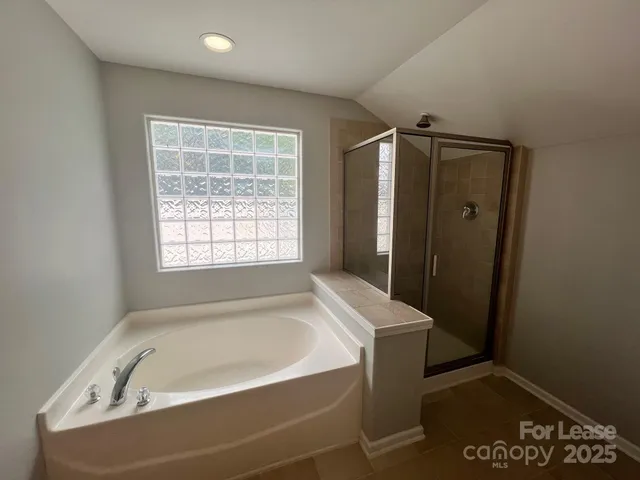 a bathroom with a bathtub and a window