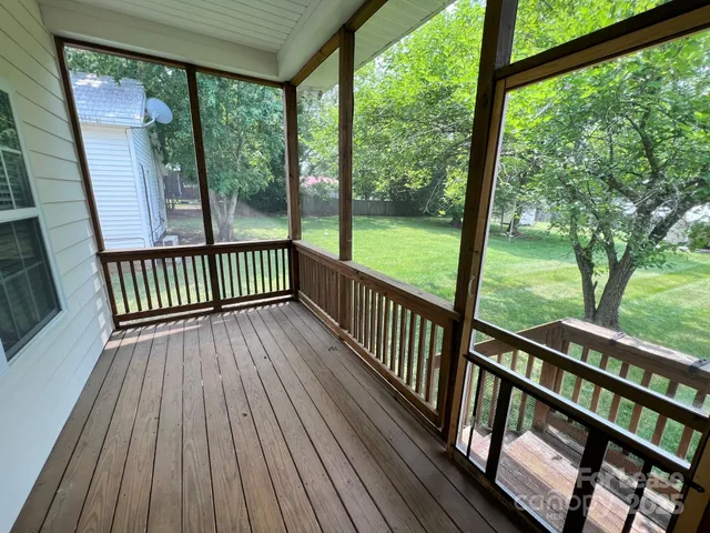 a view of a wooden deck with a yard