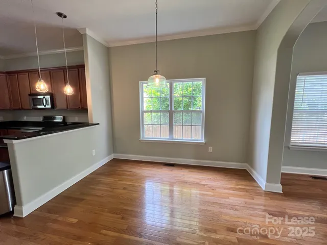 a view of a room with wooden floor and window