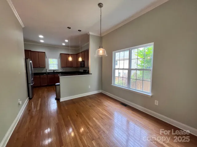 a view of a kitchen wooden floor and a kitchen