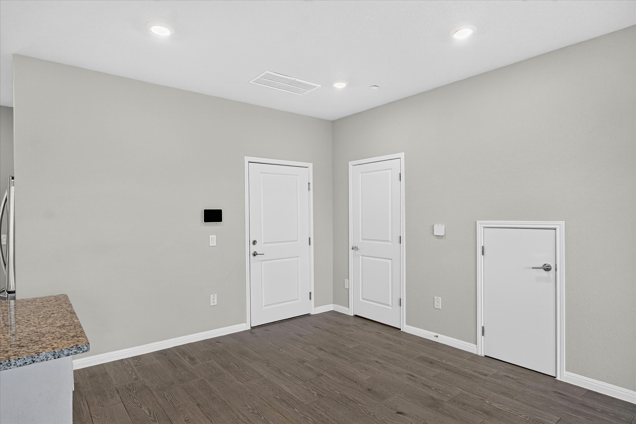 9015 Cattle Baron Path, Unit 1102 Austin, TX 78747 - Photo 9 of 25 Granite counters complement the rich wood flooring in this versatile living space.