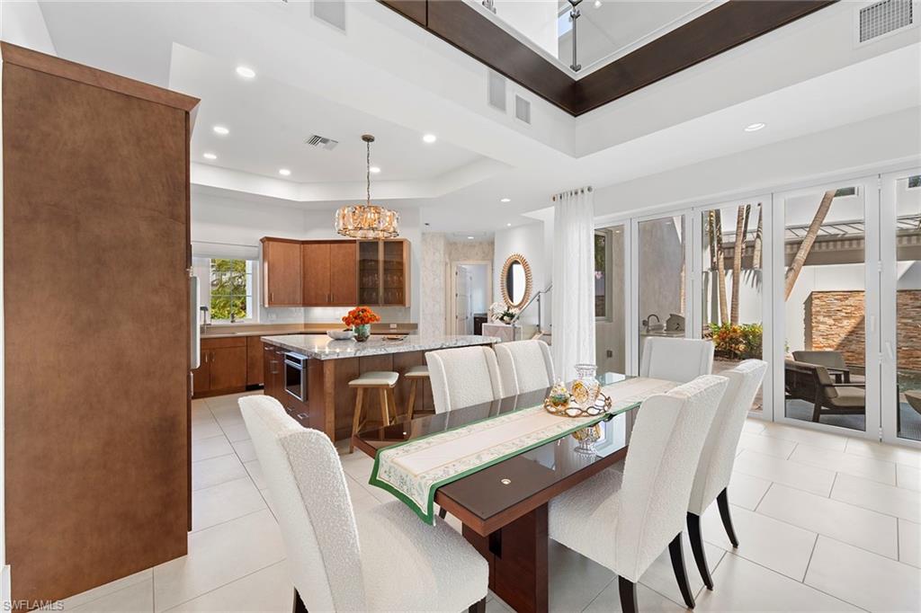 9149 Mercato Way Naples, FL 34108 - Photo 11 of 39 a living room with stainless steel appliances furniture and a kitchen view