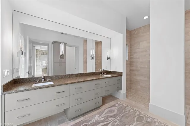 a bathroom with a granite countertop sink mirror and double