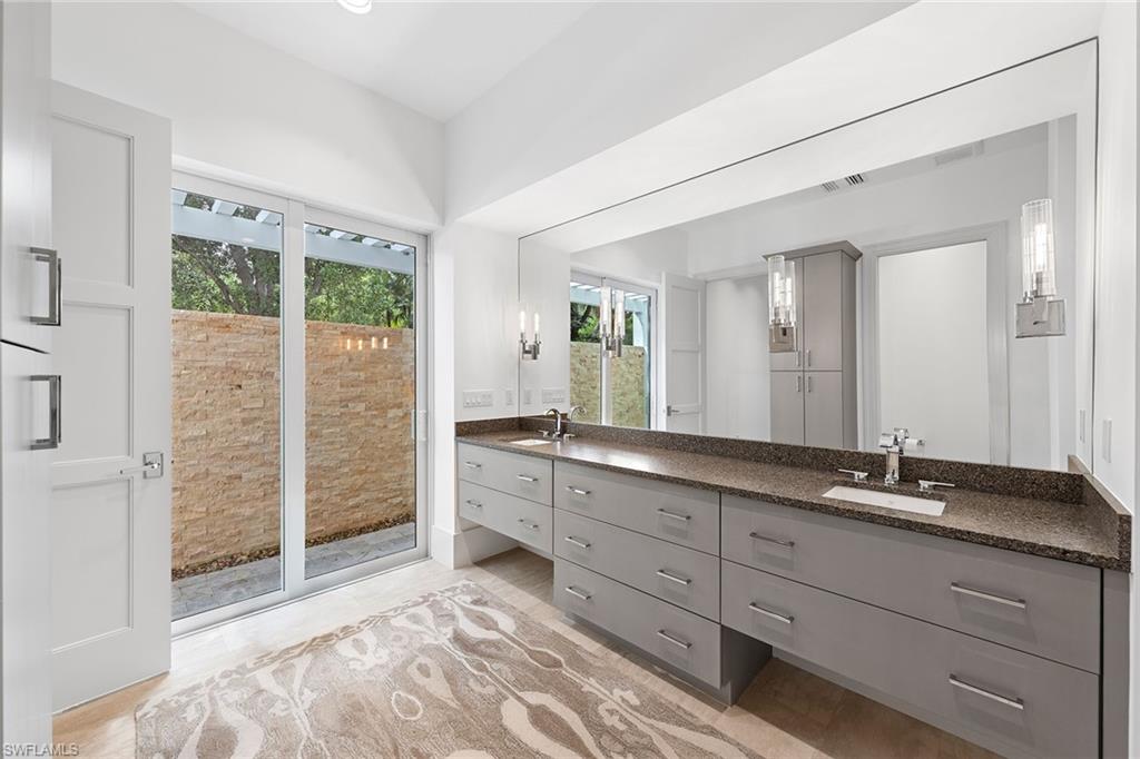 9149 Mercato Way Naples, FL 34108 - Photo 17 of 39 a spacious bathroom with a granite countertop sink mirror and double