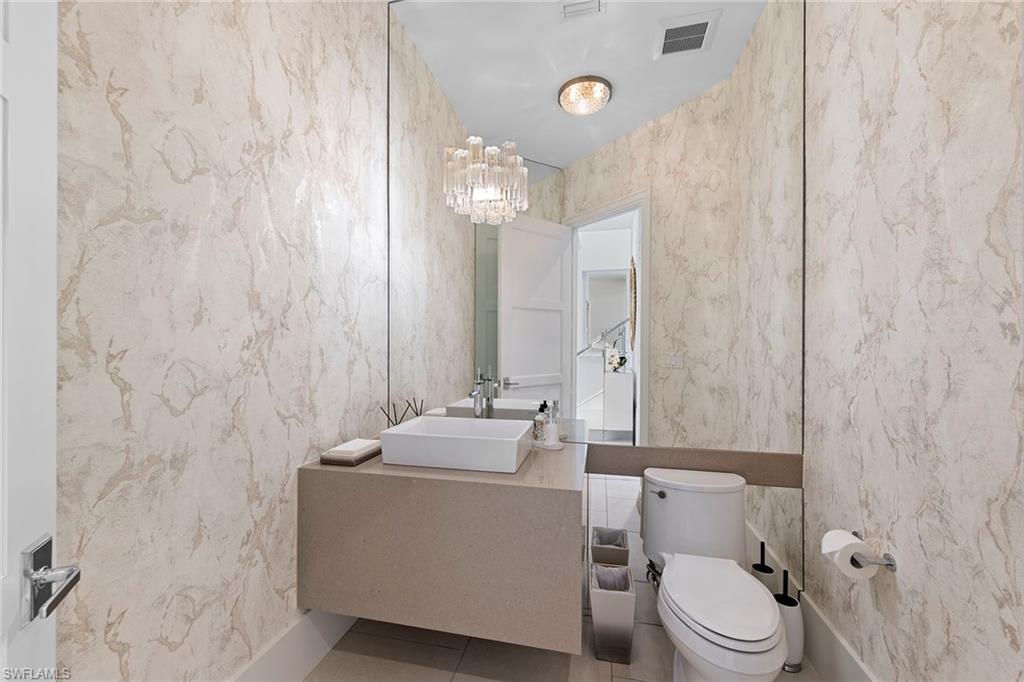 9149 Mercato Way Naples, FL 34108 - Photo 19 of 39 a bathroom with a sink a toilet and shower