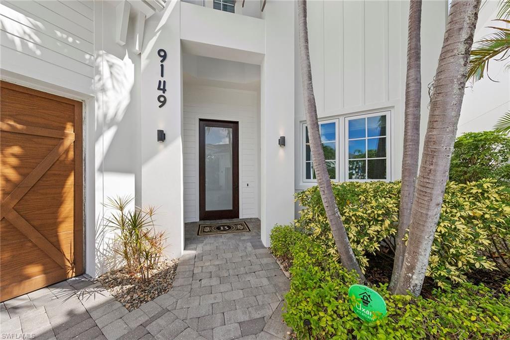 9149 Mercato Way Naples, FL 34108 - Photo 2 of 39 a front view of a house with a yard
