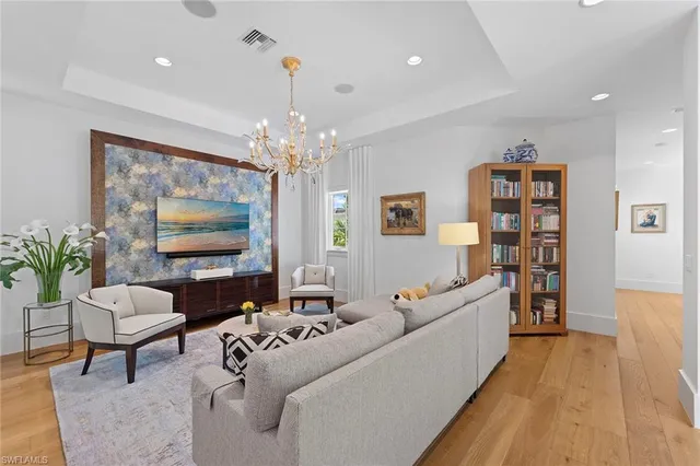 a living room with furniture and a chandelier