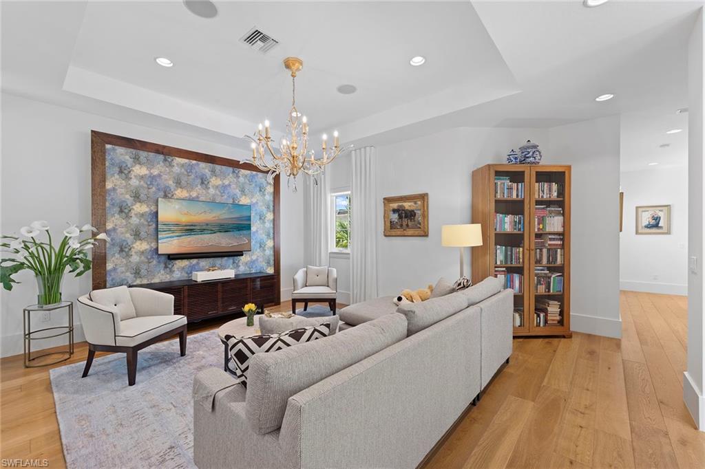 9149 Mercato Way Naples, FL 34108 - Photo 21 of 39 a living room with furniture and a chandelier