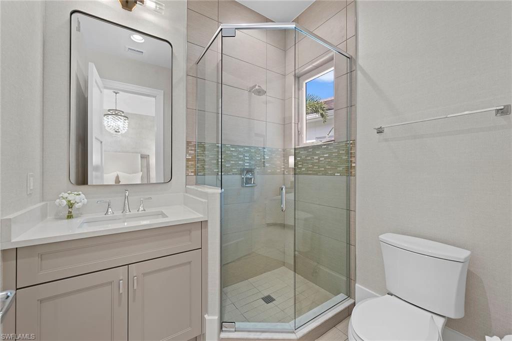 9149 Mercato Way Naples, FL 34108 - Photo 29 of 39 a bathroom with a shower sink vanity and mirror